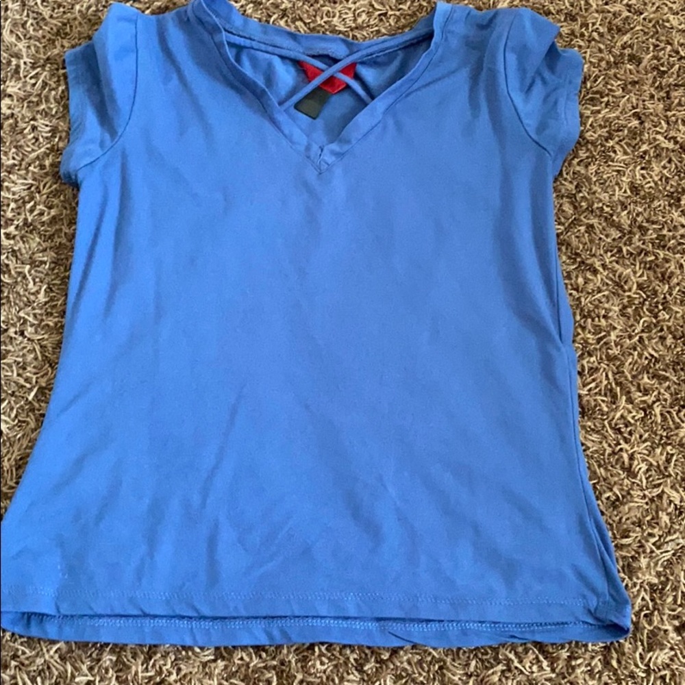 blue shirt with cross near the neck